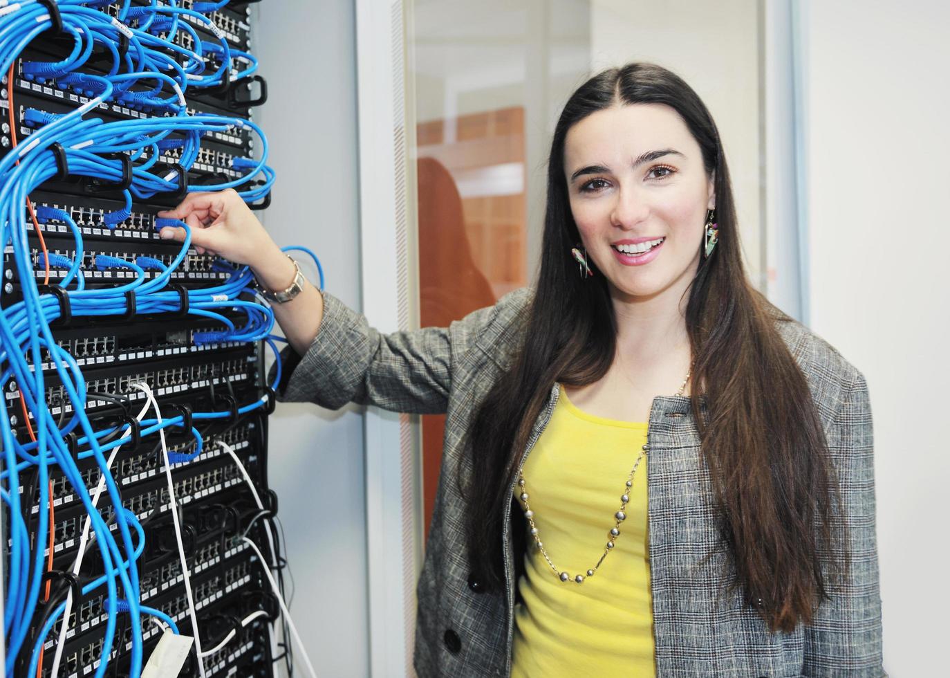 woman it engineer in network server room photo