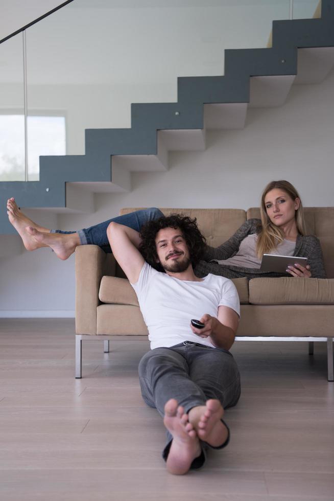 young couple relaxes in the living room photo