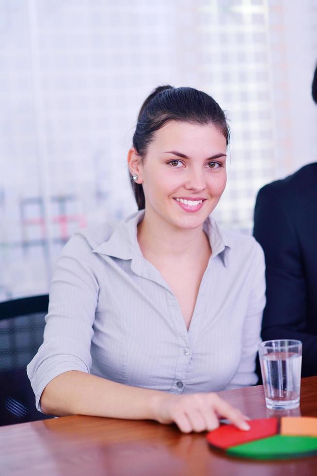 business woman with her staff in background at office photo
