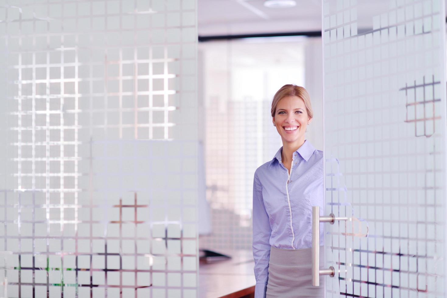 business woman with her staff in background at office photo