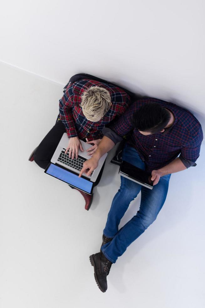 top view of  couple working on laptop computer at startup office photo