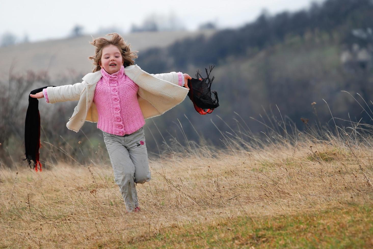 beautiful running girl on meadow  with wind in their hair photo