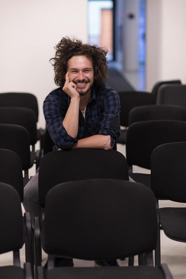 A student sits alone  in a classroom photo