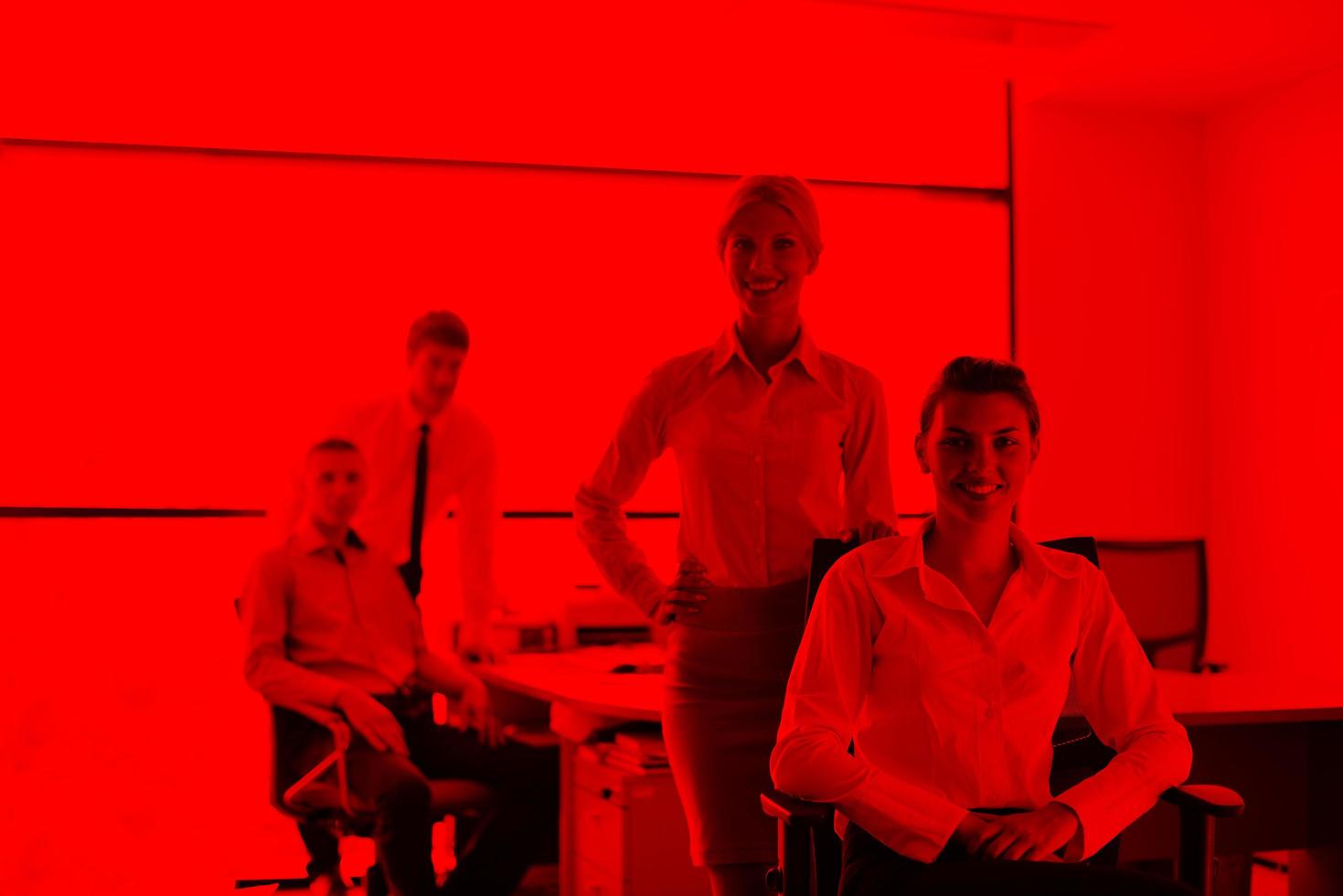 business woman with her staff in background at office photo