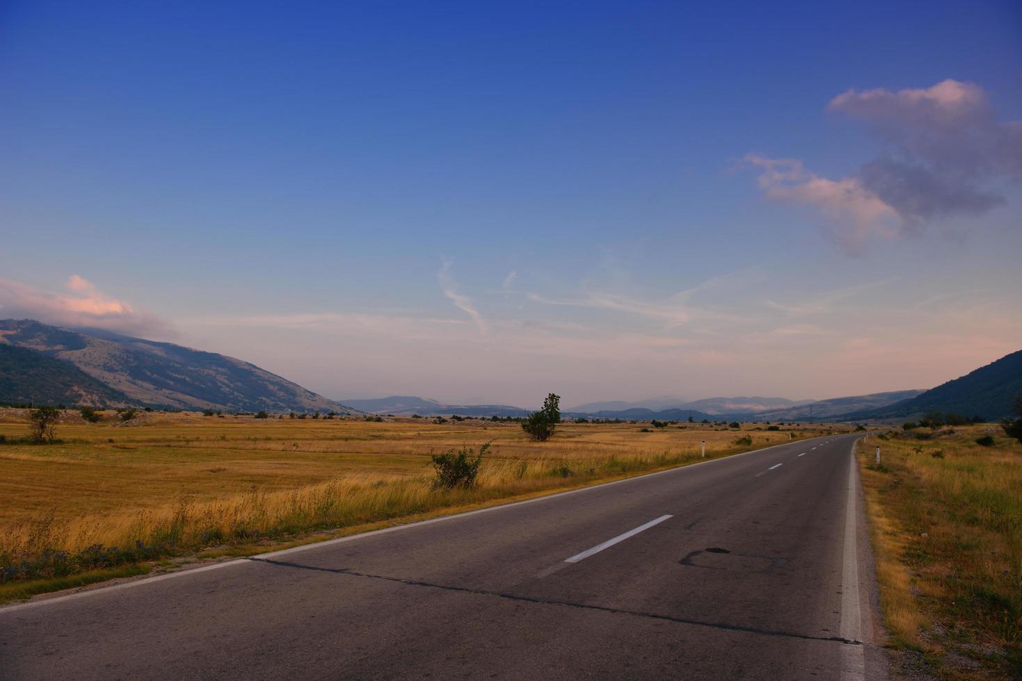 road through the green field photo