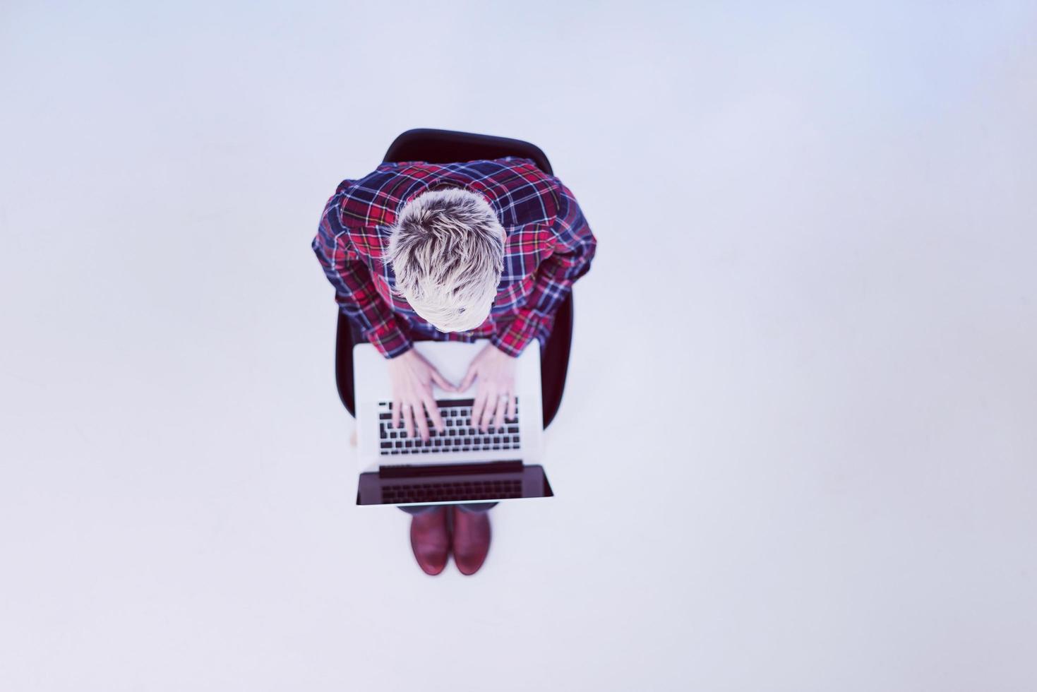top view of young business woman working on laptop computer photo