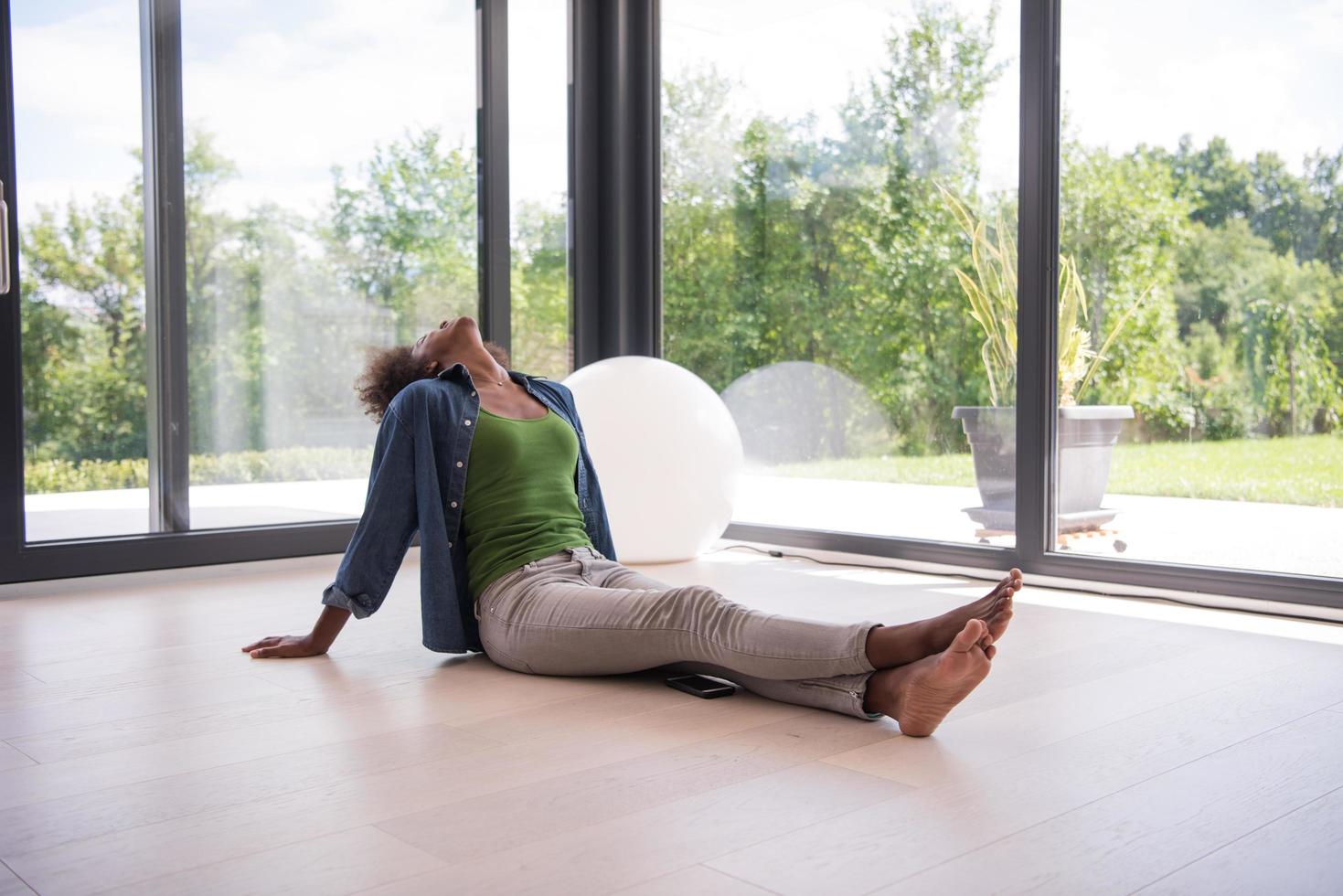 african american  woman  sitting near window photo