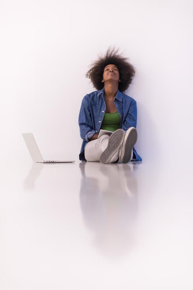 african american woman sitting on floor with laptop photo