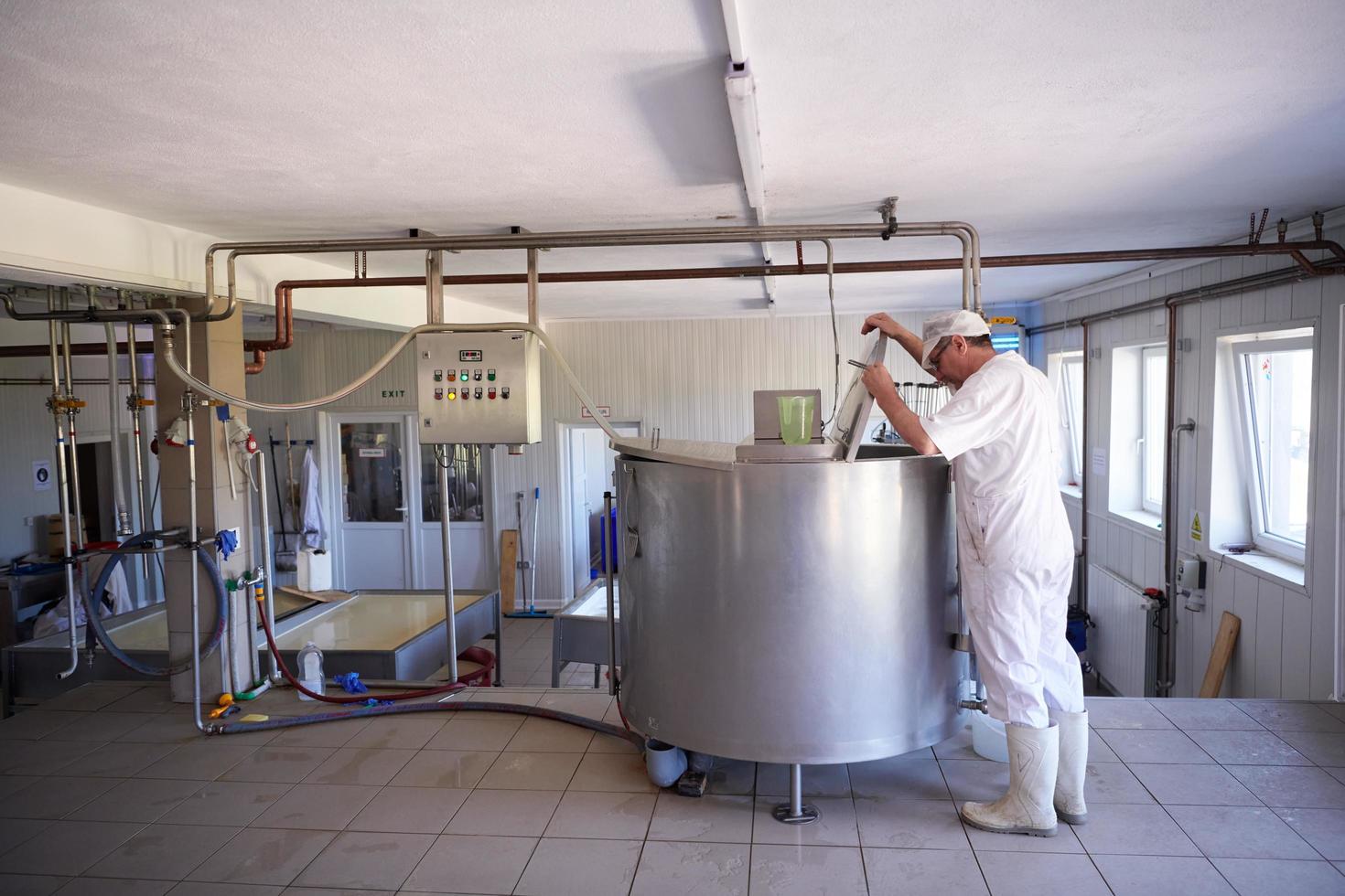 Cheese production cheesemaker  working in factory photo