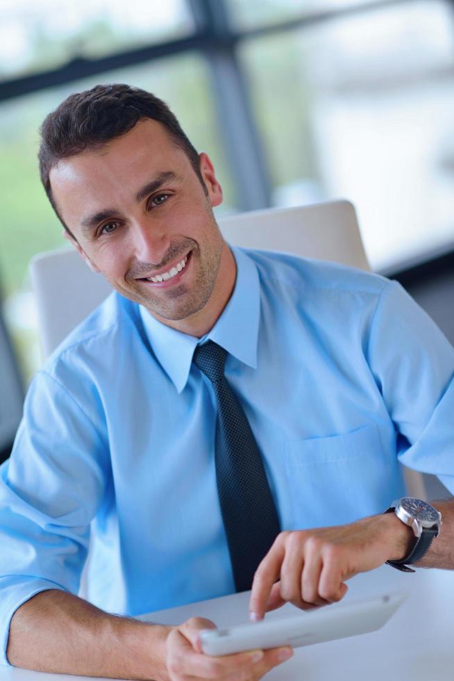 business man using tablet compuer at office photo