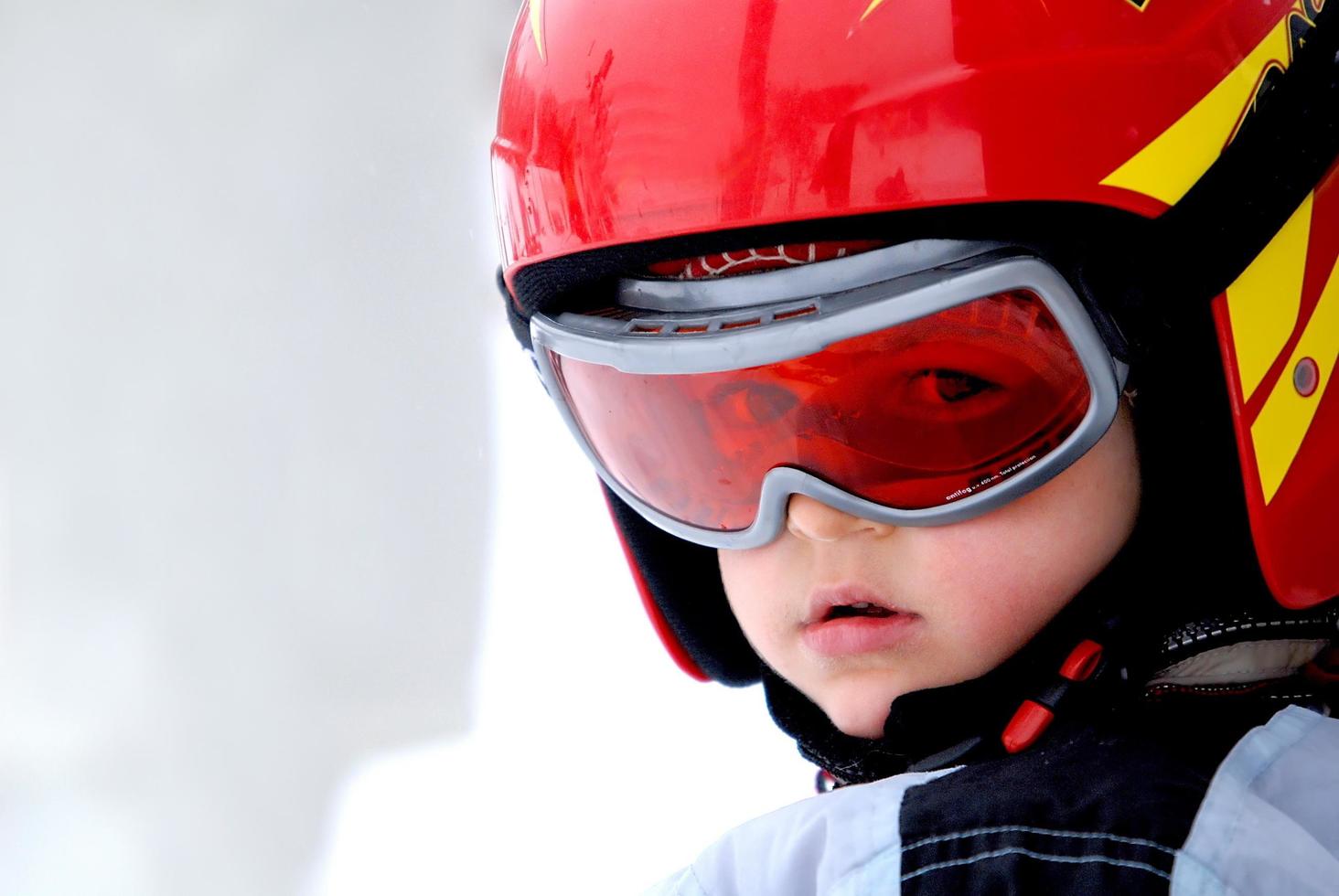 Little skier with helmet and goggles photo