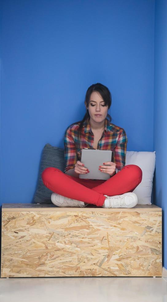 woman in crative box working on tablet photo