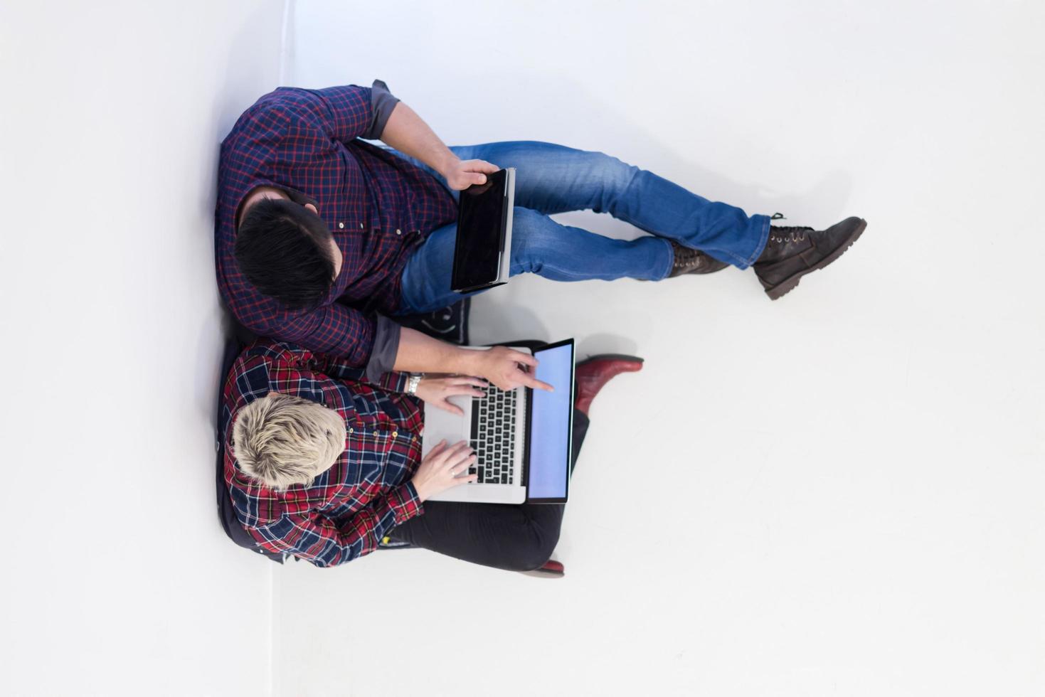 top view of  couple working on laptop computer at startup office photo