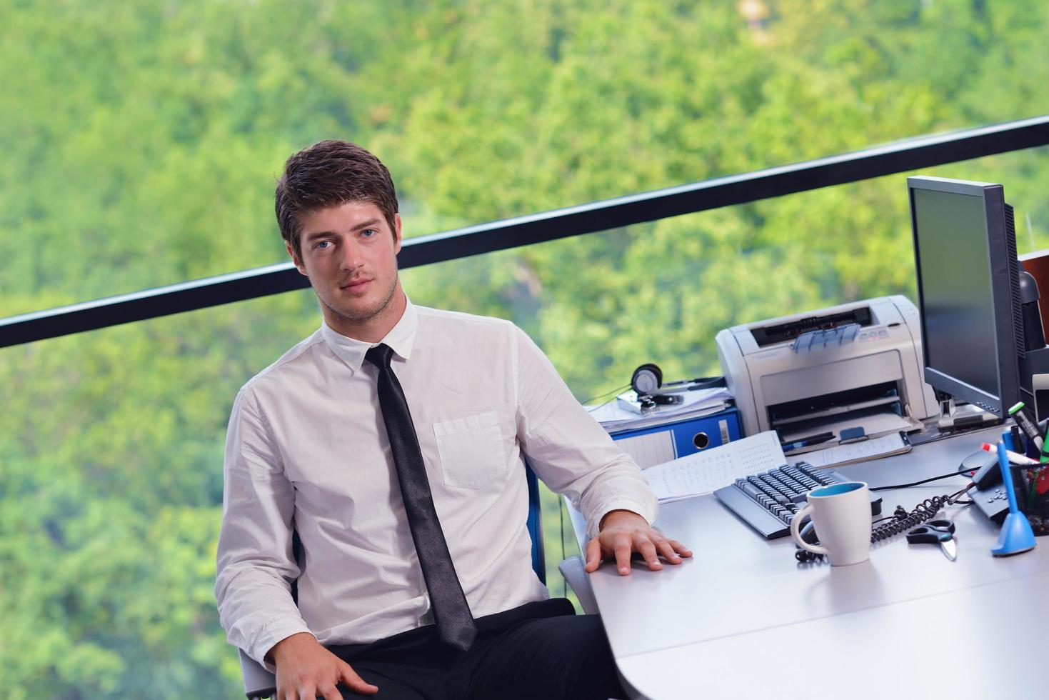 happy young business man at office photo