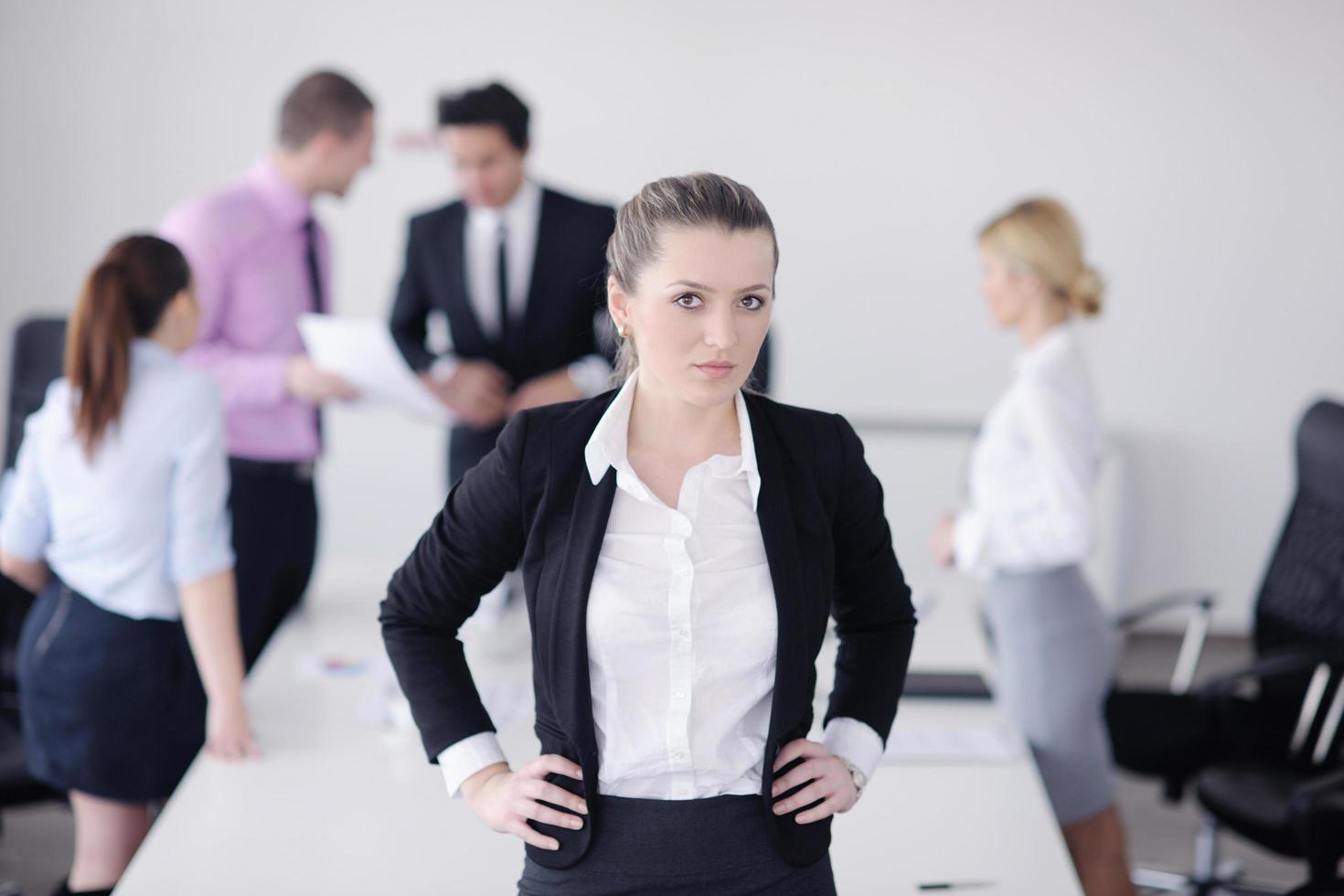 business woman standing with her staff in background photo