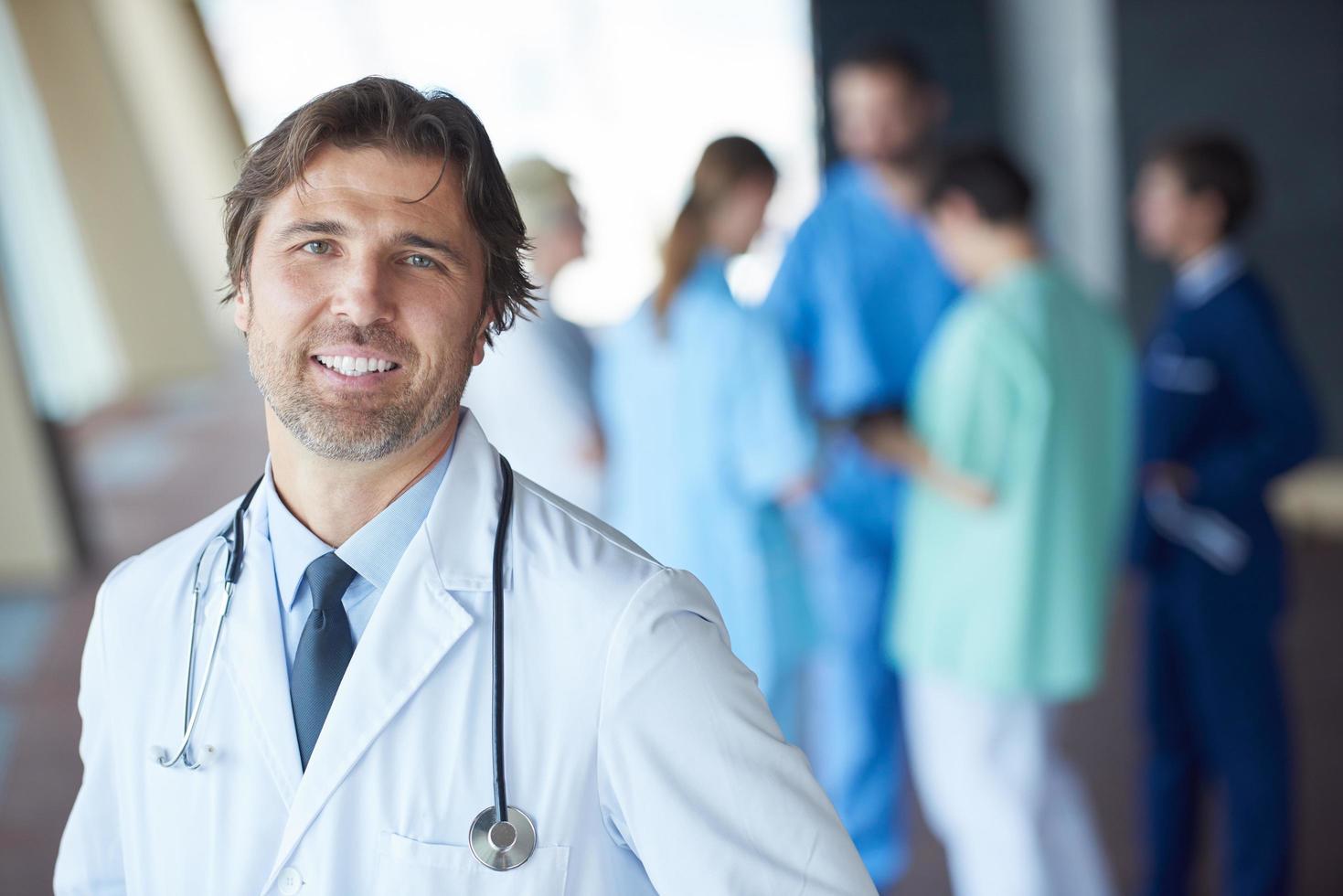 group of medical staff at hospital, handsome doctor in front of team photo