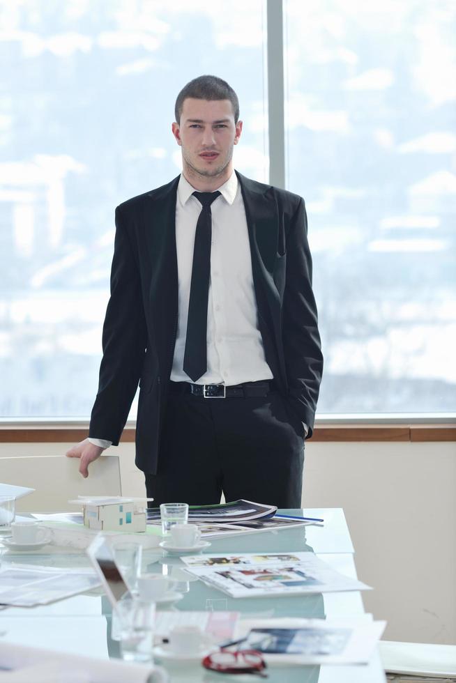 young business man alone in conference room photo