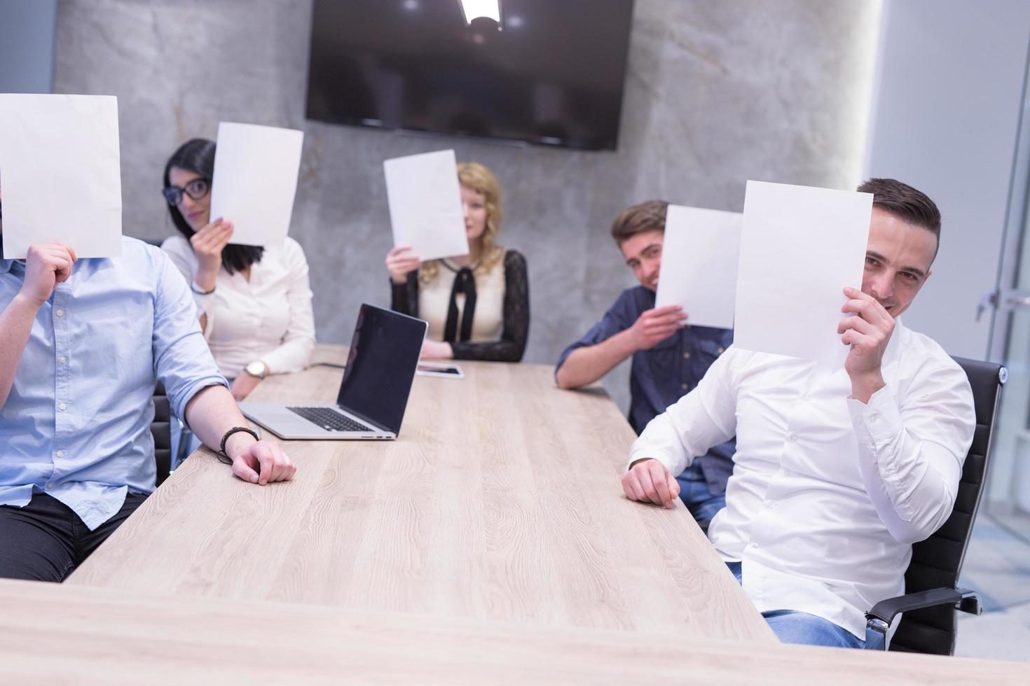 startup business team holding a white paper over face photo