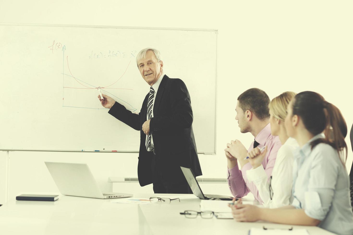 Senior business man giving a presentation photo
