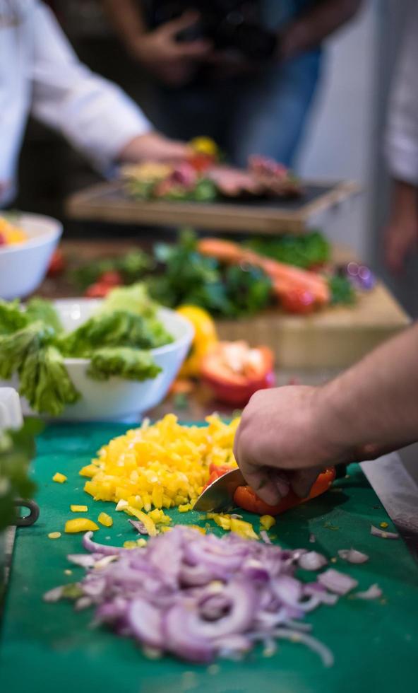 Chef hands cutting fresh and delicious vegetables photo