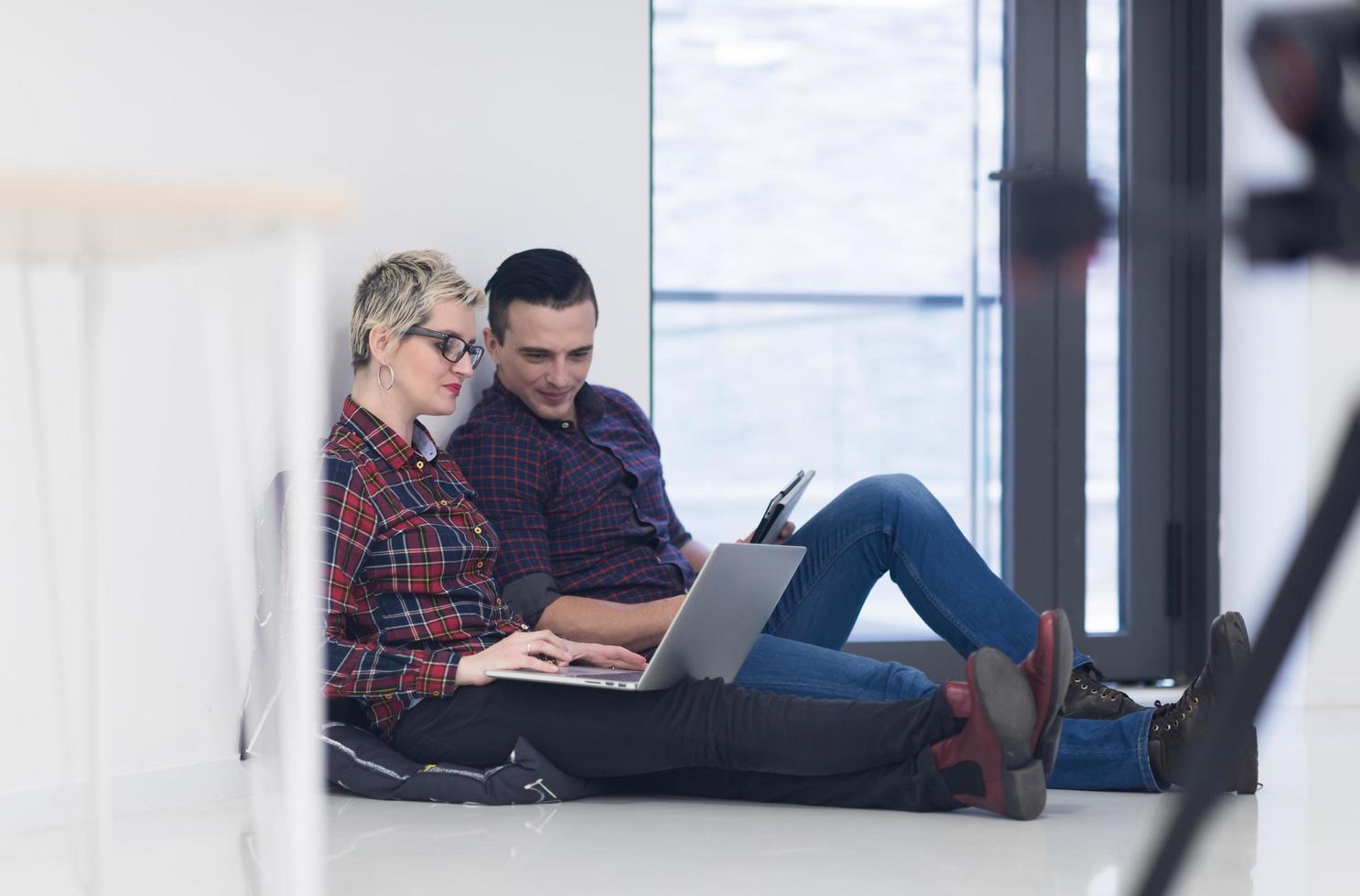 startup business, couple working on laptop computer at office photo
