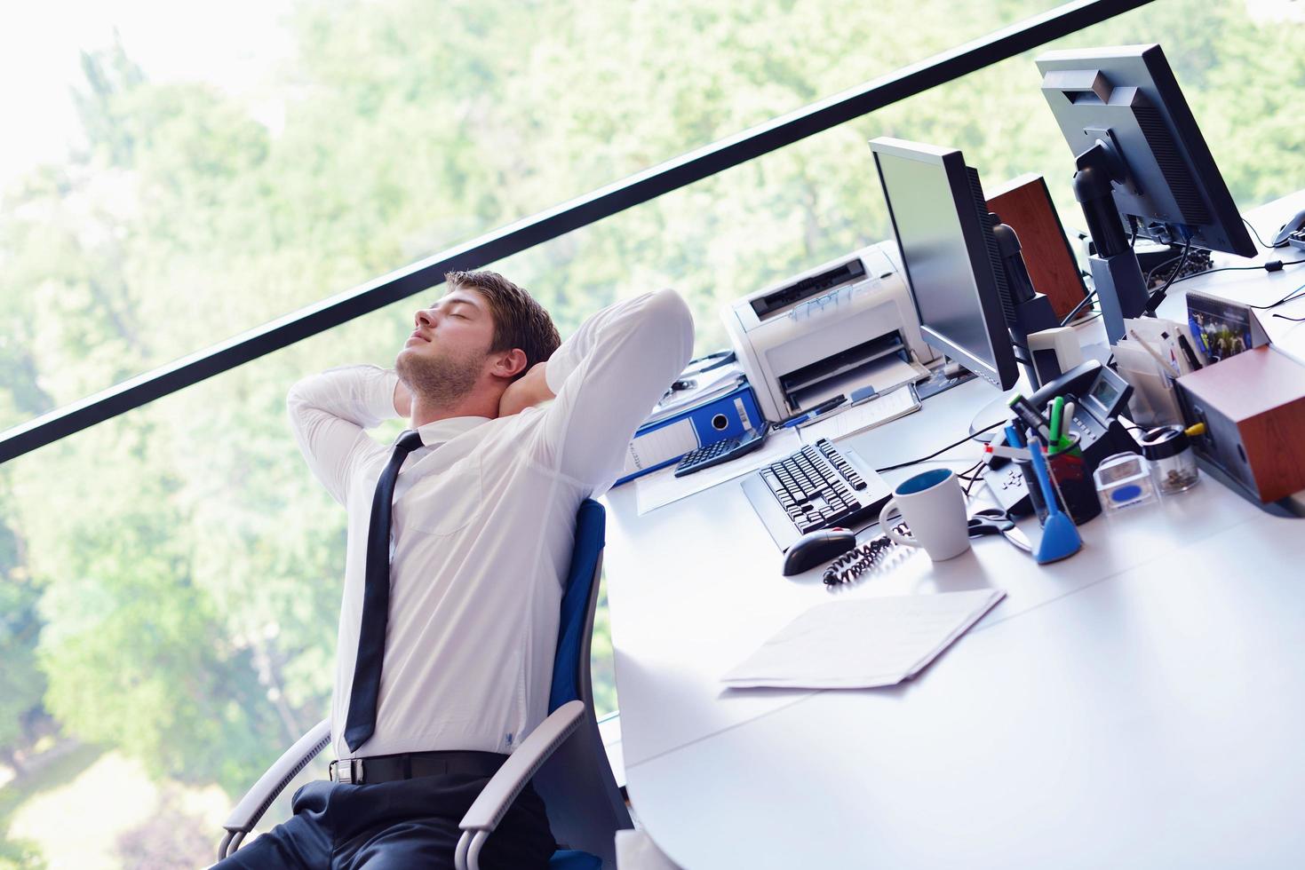 happy young business man at office photo