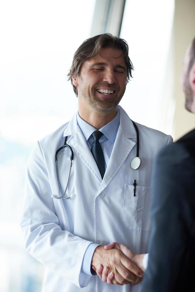 doctor handshake with a patient photo