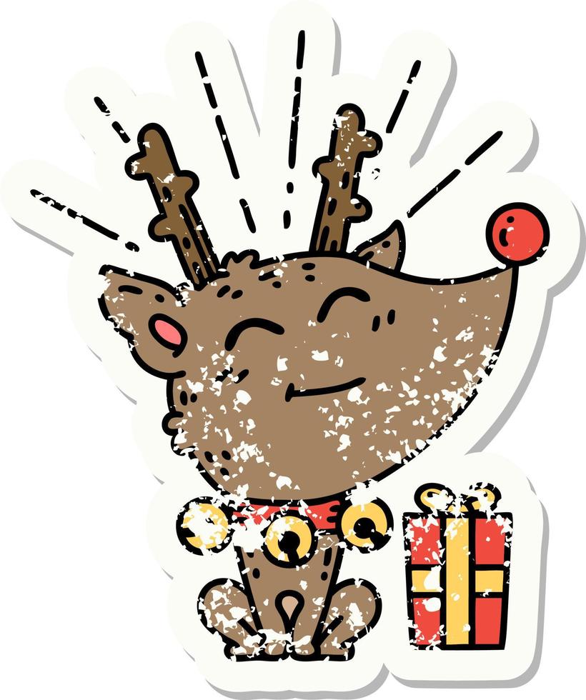 grunge sticker of tattoo style christmas reindeer with present vector