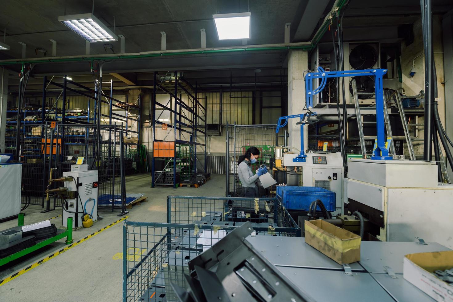 Turkey, 2022 - woman working in the metal industry in the production of new machines wears a face mask during work due to the coronavirus pandemic photo