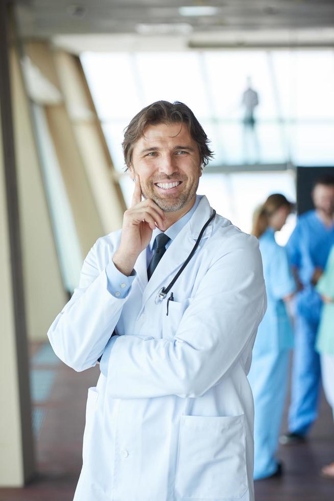 group of medical staff at hospital, handsome doctor in front of team photo