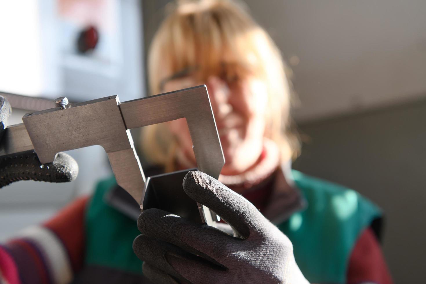 woman working in a modern factory and preparing materia for a CNC machine. photo