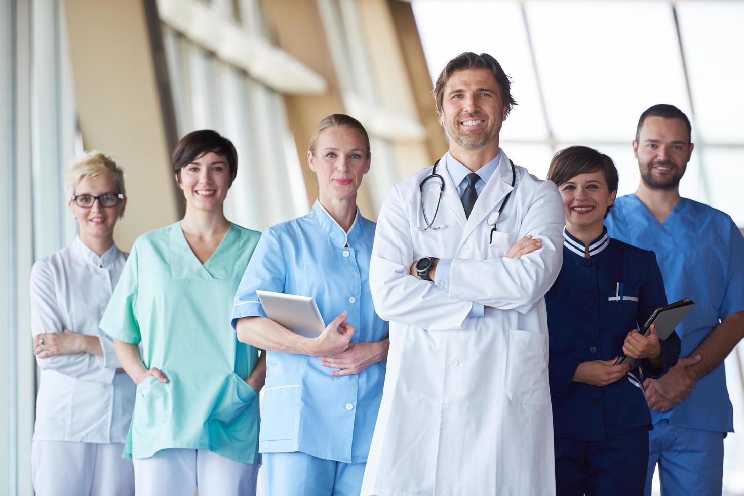 group of medical staff at hospital, handsome doctor in front of team photo