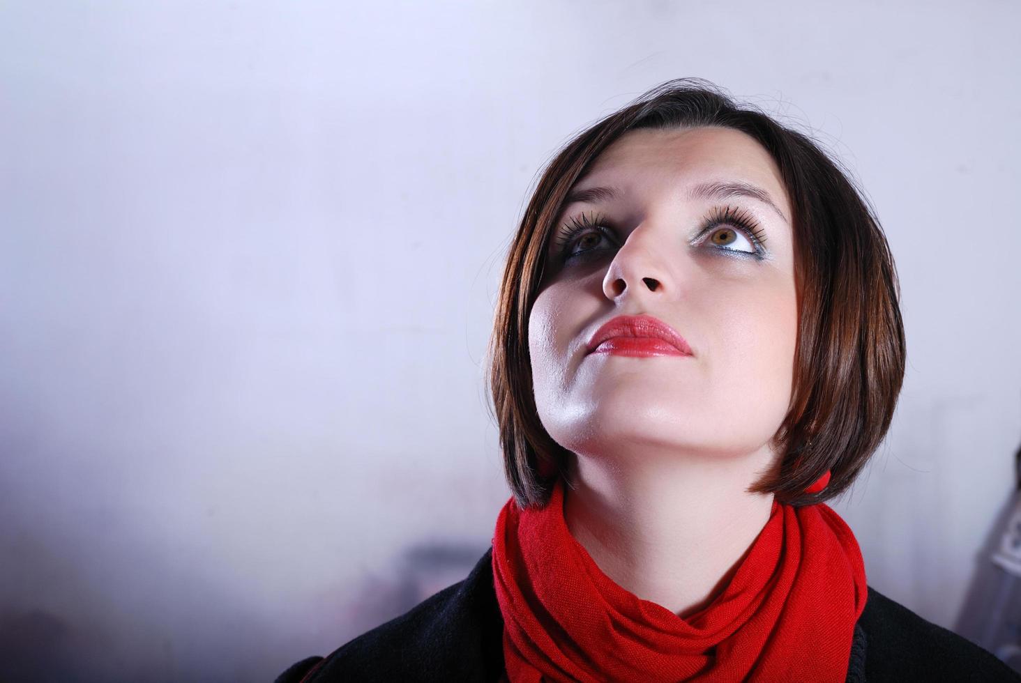 Portrait of a young woman wearing red scarf photo