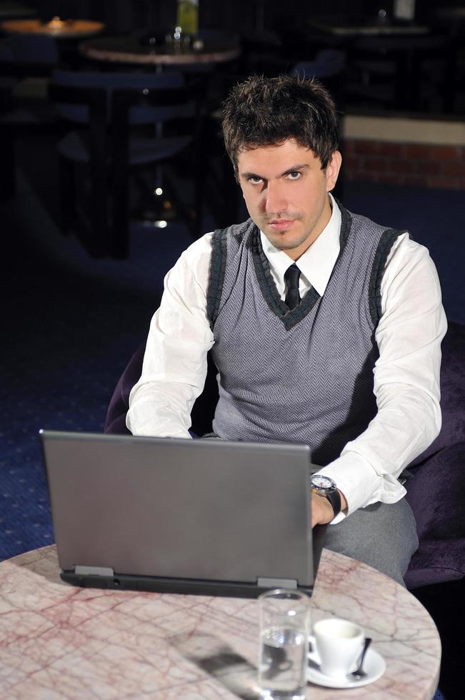 young businessman working on laptop photo