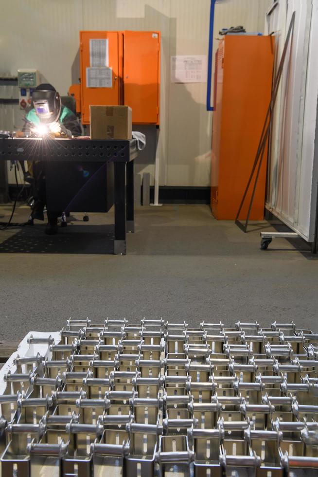 The first phase of metal and aluminum processing. Processed products from CNC machines stacked on a pallet in a large modern factory photo