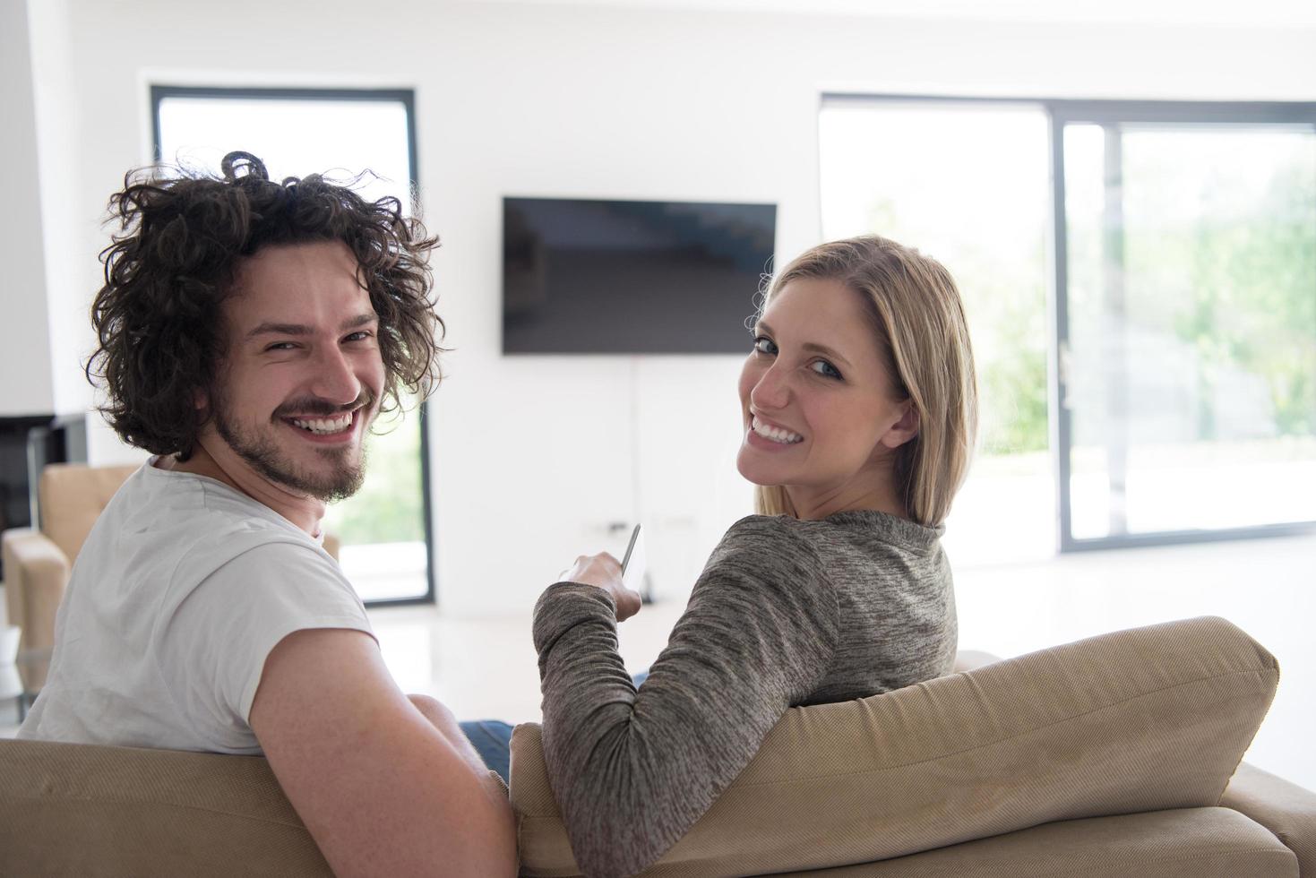 Rear view of couple watching television photo