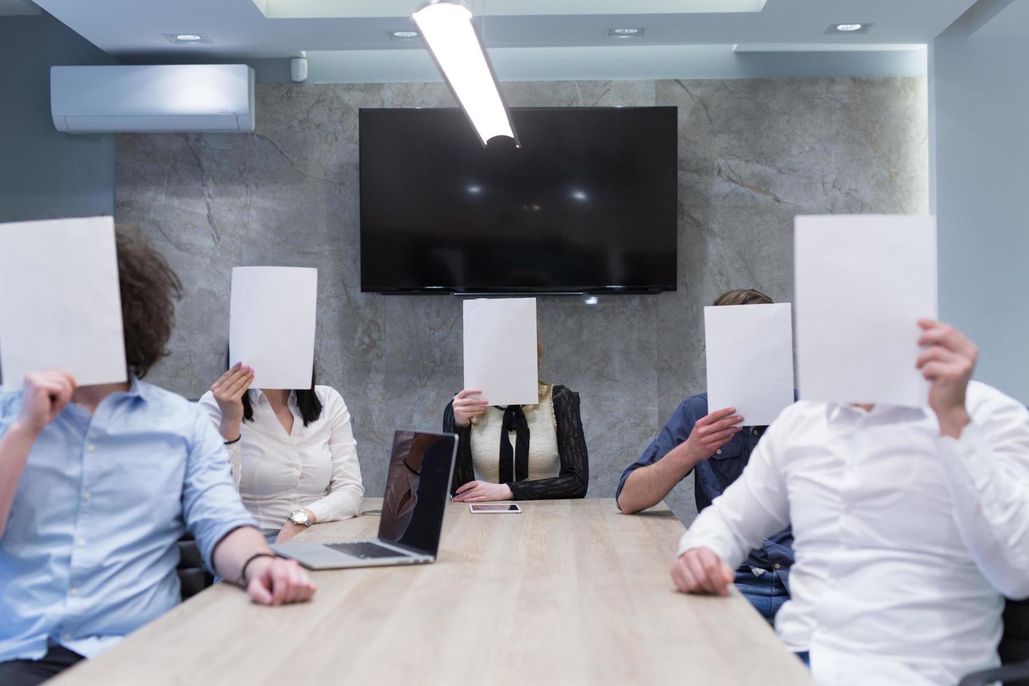 startup business team holding a white paper over face photo