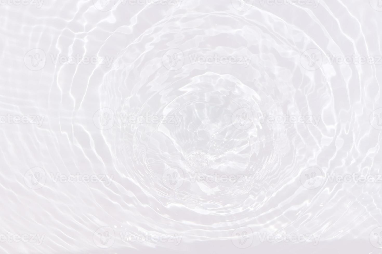 Defocus blurred transparent white colored clear calm water surface texture with splash, bubble. Shining white water ripple background. Surface of water in swimming pool. White bubble water shining. photo