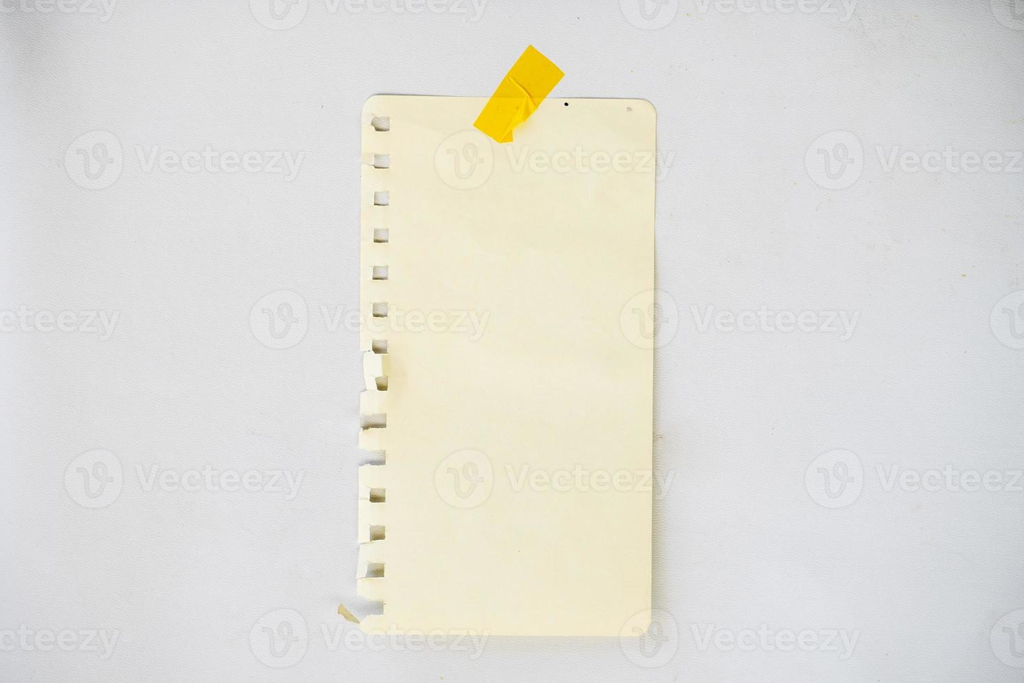blank sticky note paper for mockup. stripe line paper glued with tape on the wall photo