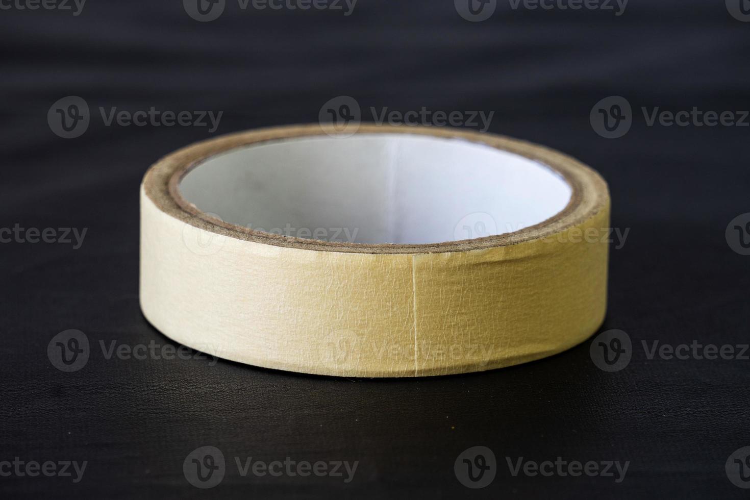 yellow paper tape isolated on black background photo