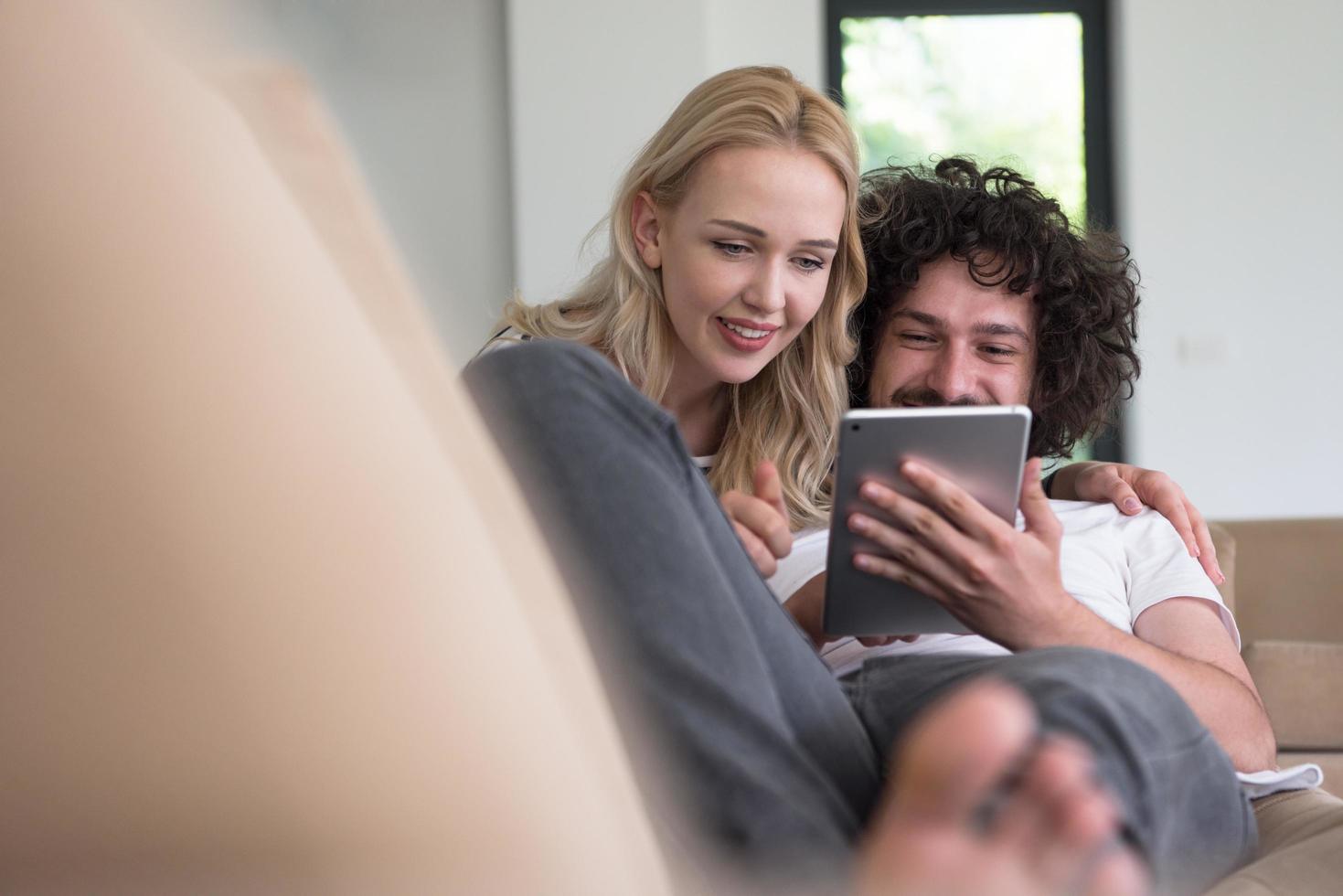 couple relaxing at  home with tablet computers photo