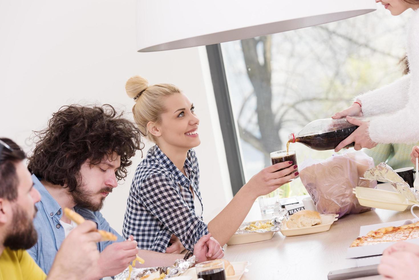 multiethnic group of happy friends lunch time photo