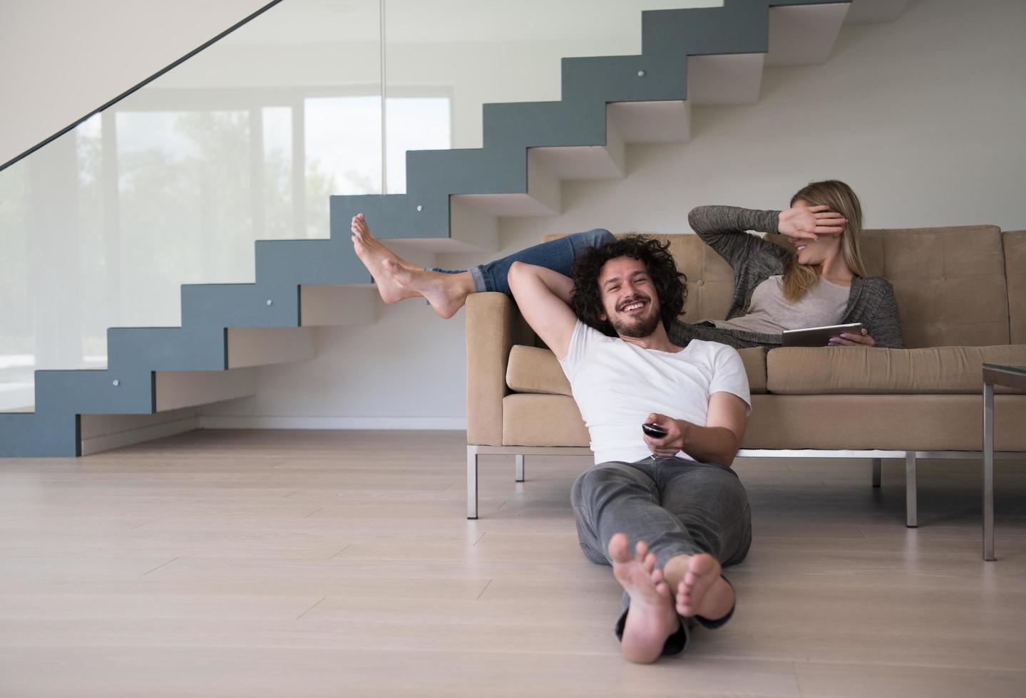 young couple relaxes in the living room photo