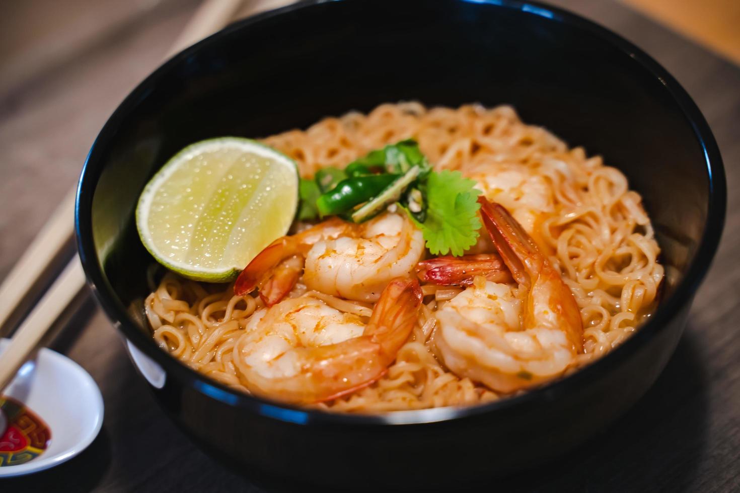 Spicy instant thai style noodles soup with shrimp - tom yum kung photo