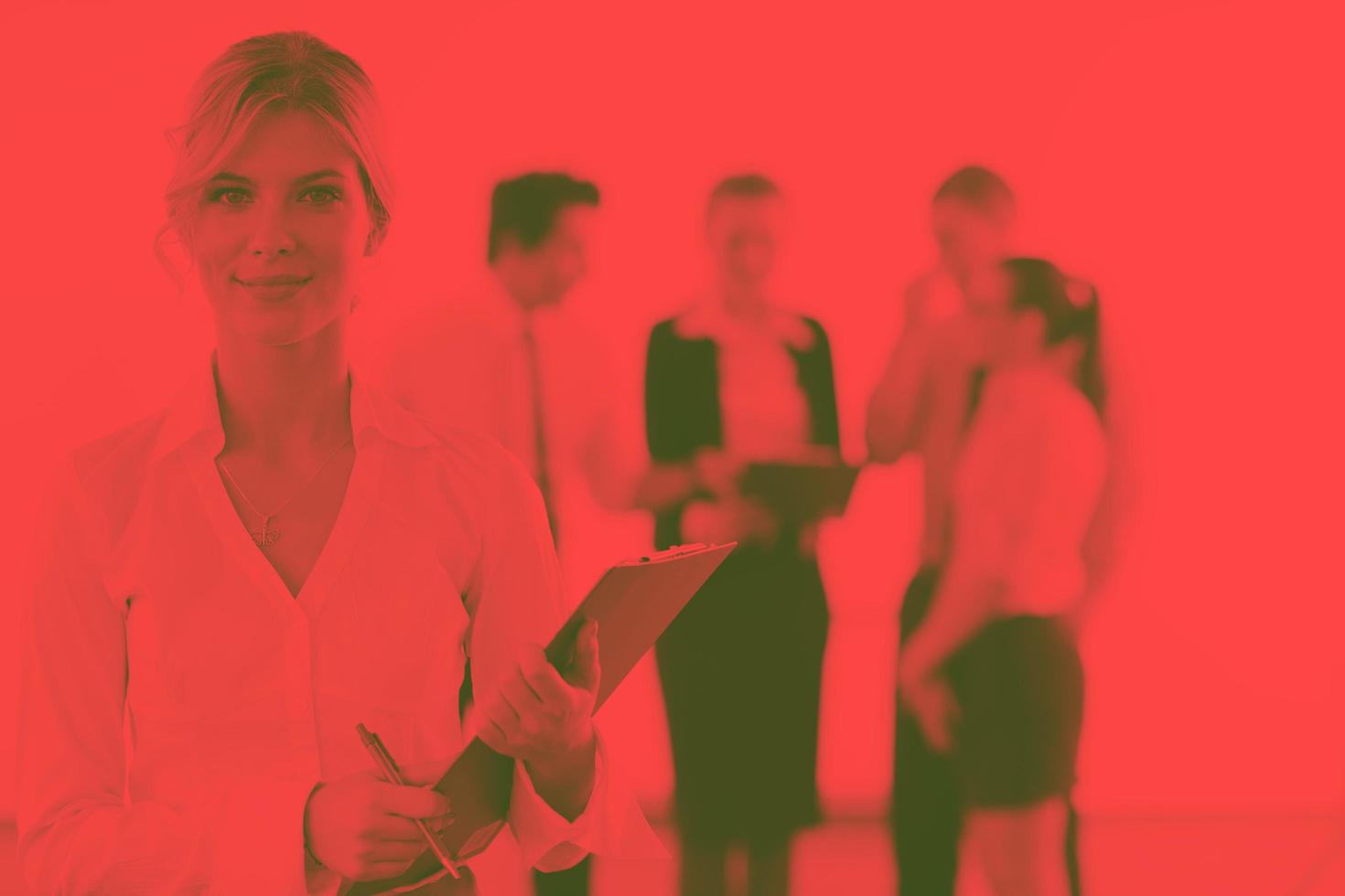 business woman standing with her staff in background photo
