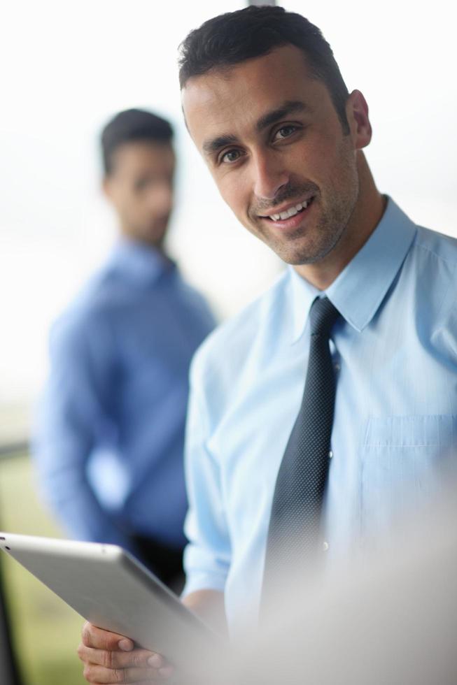 business man using tablet compuer at office photo