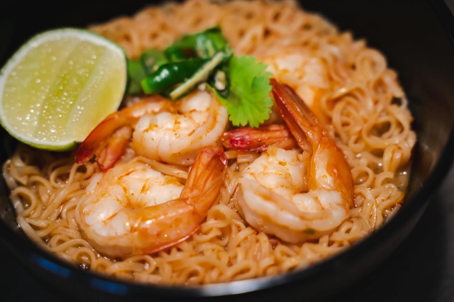 Spicy instant thai style noodles soup with shrimp - tom yum kung photo