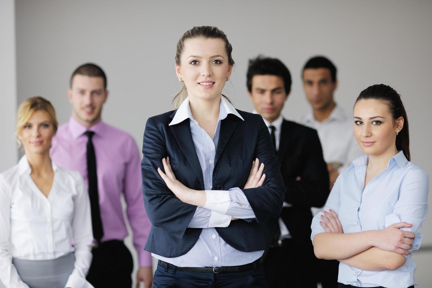 business woman standing with her staff in background photo