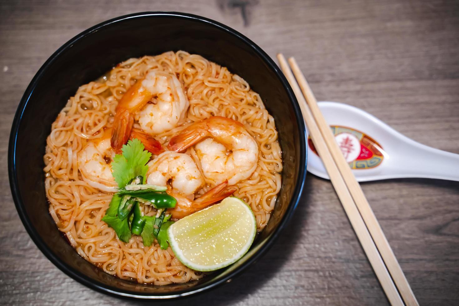 Spicy instant thai style noodles soup with shrimp - tom yum kung photo