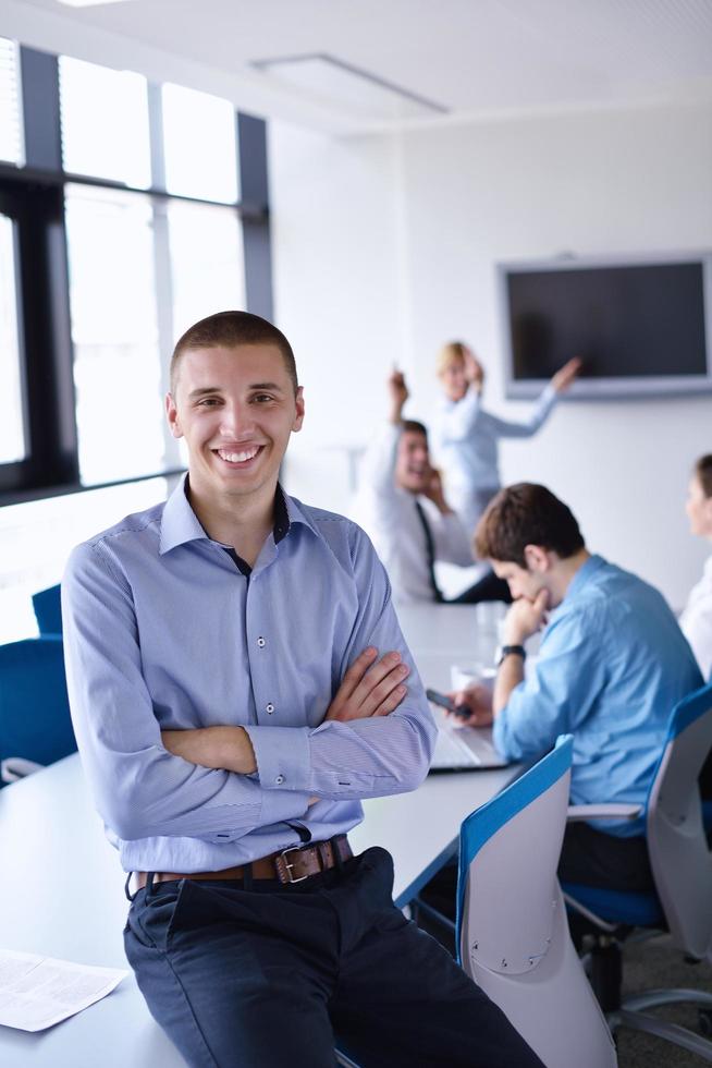 business man  on a meeting in offce with colleagues in background photo